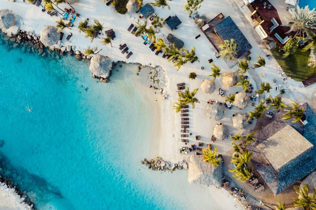 Active beachgoers enjoying yoga and other outdoor activities on Curacao's serene sandy beaches