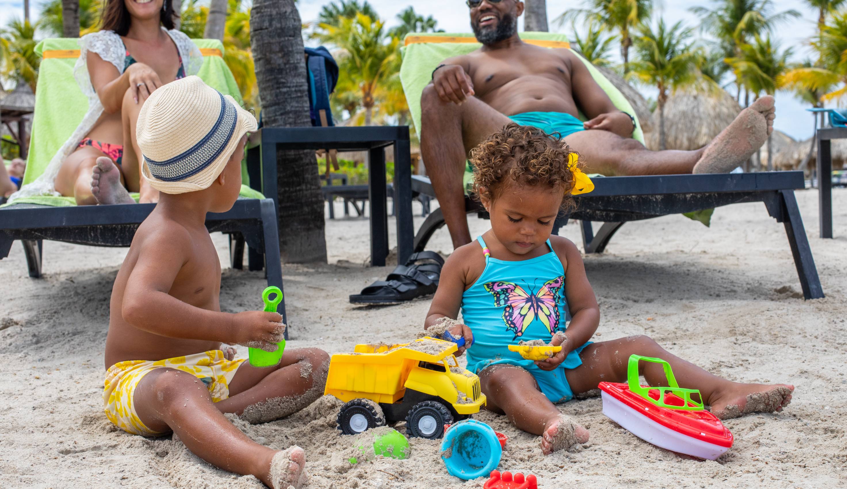 Family playing in sand at Mambo Beach
